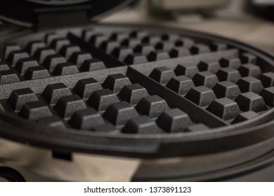 A Closeup Of A Waffle Iron Grill Surface