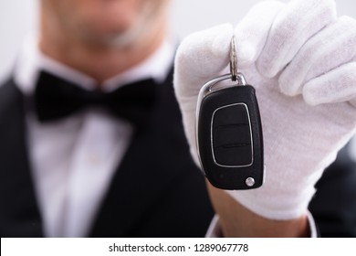 Close-up Of Waiter Wearing Handgloves Holding Car Key