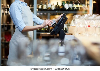 Close-up of waitress registrating orders at the cash desk - Shutterstock ID 1038204025