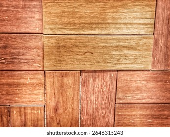 A close-up of a wall constructed from rectangular wooden blocks, arranged symmetrically to form a pattern similar to bricks. It showcases warm natural wood grain and tones, ideal for background 