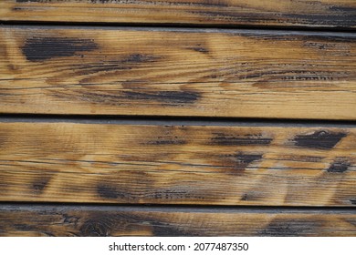 Closeup of wall made of burnt and brushed wooden planks