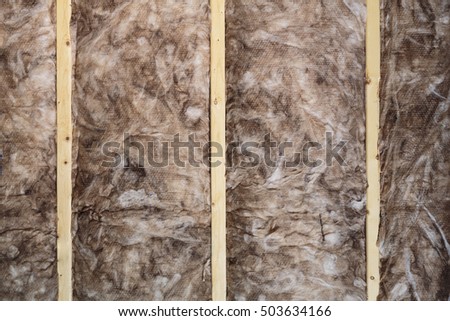 Closeup of a wall that is under construction with insulation.