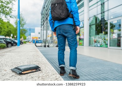 Close-up of wallet lying on the bench and outgoing person