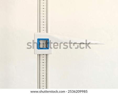 Close-up of a wall-mounted height measuring scale in a medical or clinical setting