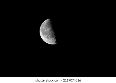 Closeup of the waning moon  - half moon - early morning against black sky. Stuttgart, Germany January 25, 2022
