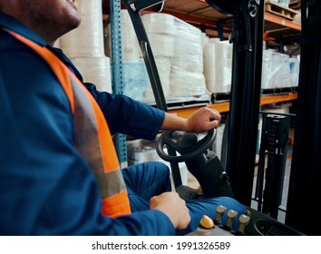 Close-up of a warehouse worker operating forklift truck - Powered by Shutterstock