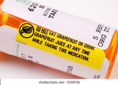 Close-up Of A Warning Label About Consuming Grapefruit On A Bottle Of Prescription Medication.