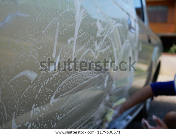 closeup washing car with\
soap.