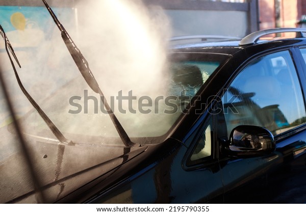 close-up\
washing a car with spray water at a car\
wash