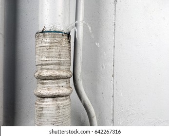 Close-up Water Burst Leaking From Broken Pipeline In House. Old Sewer Pipe Leakage After The Rain.