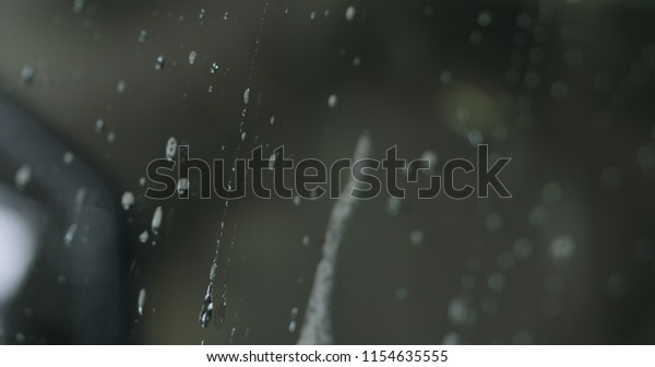 closeup water\
drop sliding down car side\
window