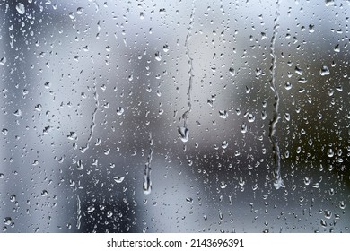 Close-up Of Water Droplets On Glass. Large Rain Drops Strike A Window Pane.