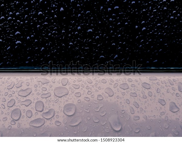 Close-up\
of Water Drops on Car Window after a heavy\
rain