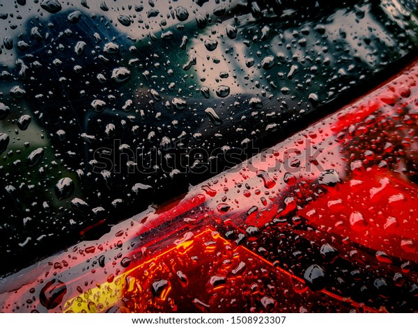 Close-up\
of Water Drops on Car LED\'s after a heavy\
rain