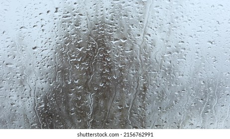 Close-up Of Water Drops On The Glass, Rain, Go Away. Large Raindrops Hit The Window Pane In Early Spring.