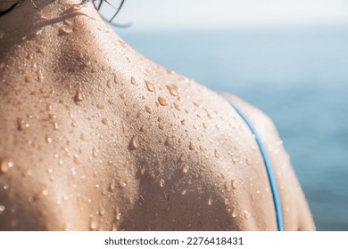 Close-up of water drops on skin - Shutterstock ID 2276418431