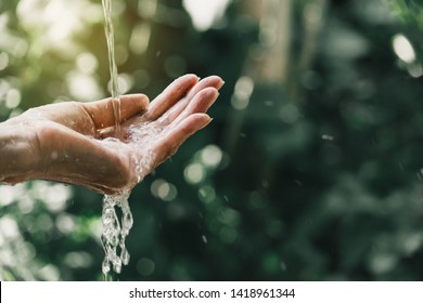 closeup water flow to hand of women for nature concept on the garden background.
 - Powered by Shutterstock