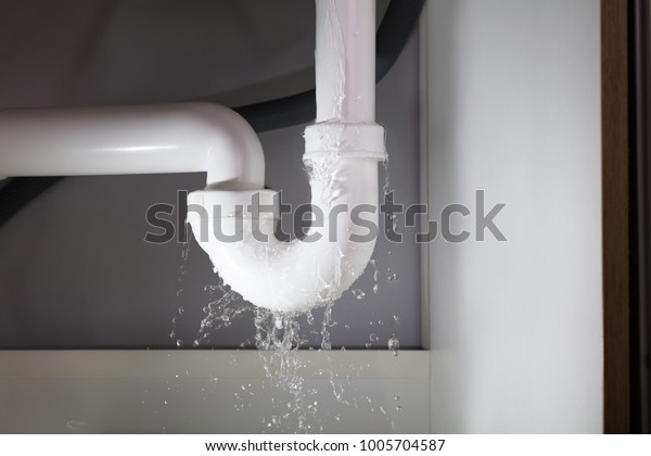 Close-up Of\
Water Is Leaking From The White Sink\
Pipe