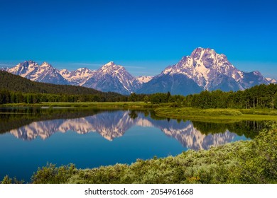 Closeup Of Water Reflecting Snow Capped Mountains In Yellowstone Wyoming