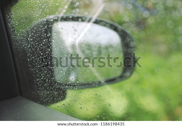 Close-up of water spray from the\
rain, car windshield selective focus and shallow depth of\
field