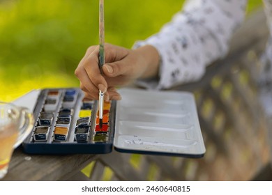 Close-up of watercolor paints and paint brush. The art of watercolor painting. - Powered by Shutterstock