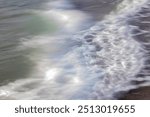 close-up of waves on the Channel coast in Normandy, France, with low shutterspeed