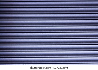 Close-up of the wavy, gray aluminum metal surface backdrop, background, texture in the sunlight - Shutterstock ID 1972302896