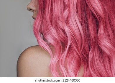 Close-up of the wavy pink hair of a young woman isolated on a gray background. Result of coloring, highlighting, perming. Beauty and fashion - Powered by Shutterstock