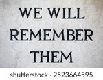 Close-up of the We Will Remember Them inscription on Hitchin War Memorial, located in the beautiful town of Hitchin in Hertfordshire, UK.