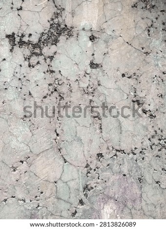 Close-up of a weathered concrete wall surface with deep cracks, erosion, and industrial grunge texture.