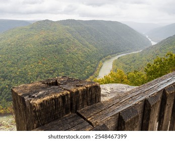 A close-up of a weathered fence post at Turkey Spur Rock and Grandview Rim in New River Gorge National Park, West Virginia, framed by the misty mountains fading softly in the distance. - Powered by Shutterstock