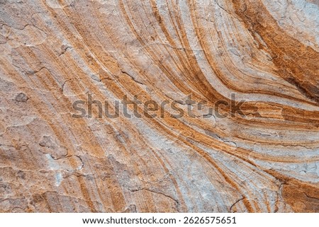 Close-up of weathered rock surface with layers.Orange and brown mineral texture for creative use.