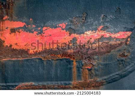 Closeup of a weathered ship hull with rust and red lead. The photo was taken in the harbor of Vlissingen, the Netherlands.