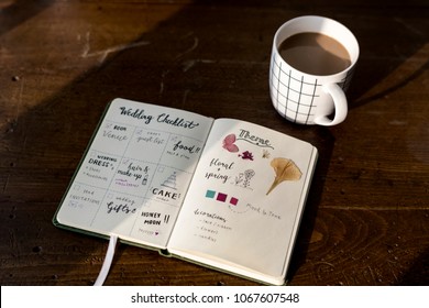 Closeup Of Wedding Checklist Notebook On Wooden Tabel