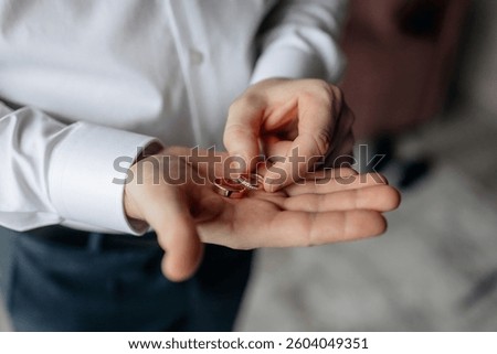 Close-up of a wedding ring for a proposal in a man's hands. An offer of a hand and a heart. wedding rings