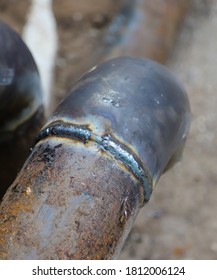 Closeup Of A Welded Butt Joint With Some Defects. Two Rusty Metal Pipes Welded Together