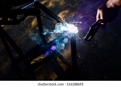 Close-up of welder working in workshop.