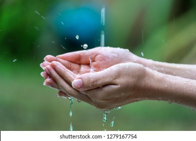 Close-up of wet female hands in rain - Powered by Shutterstock