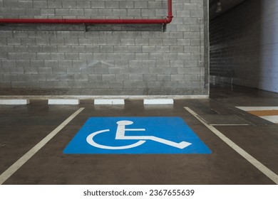 Close-up of a wheelchair parking space in an indoor parking lot. concept of accessible locations