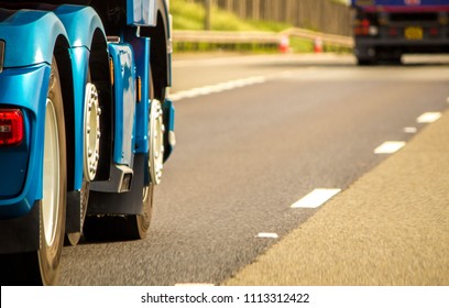 A Closeup Of Wheels In Motion From An Articulated Lorry, Travelling Along A UK Motorway.