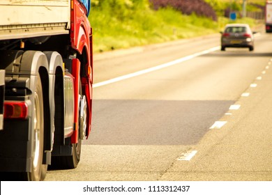 A Closeup Of Wheels In Motion From An Articulated Lorry, Travelling Along A UK Motorway.