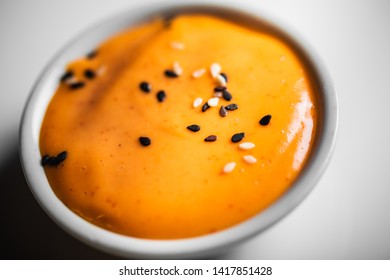 Closeup Of White Bowl With Spicy Mayo Sauce With Sesame Seeds For Sushi