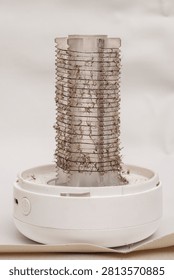 Close-up of a white bug zapper covered in dead mosquitoes. Shows effective pest management and insect bite prevention indoors.