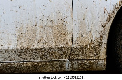 Close-up Of White Car Covered With Mud In Autumn.