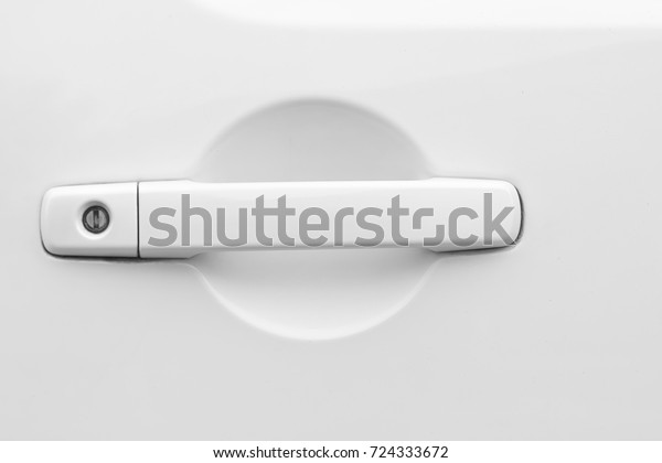 Closeup of white car door\
handle