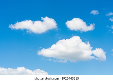 Closeup of white clouds on sunny blue sky background