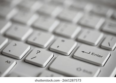 Close-up of White Computer Keyboard with Question Mark and Enter Keys in Focus