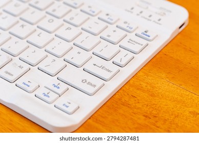 Closeup of white computer keyboard with selective focus on Enter key
