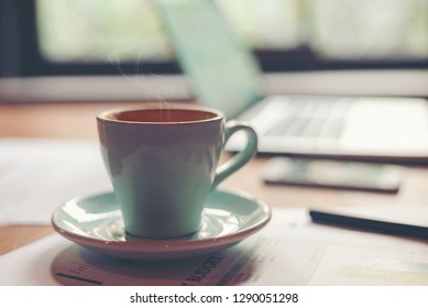 Closeup White Cup Of Coffee Break In The Work Space. Vintage Tone 