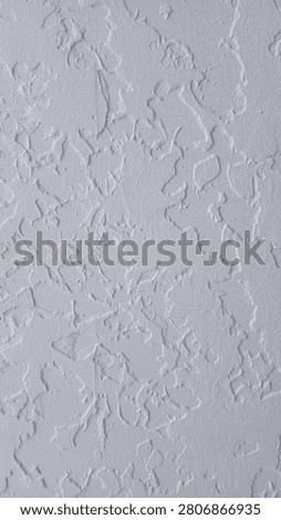 Close-up of white decorative plaster wall texture, knockdown stucco ceiling background